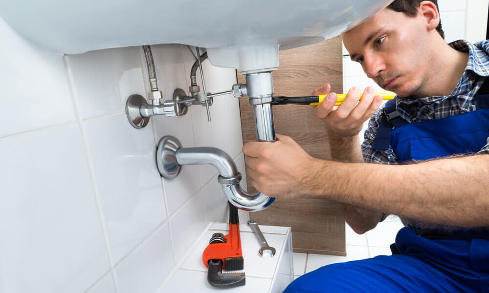 Plumber working on a sink installation